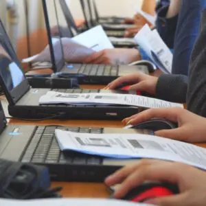 People using laptops in a classroom